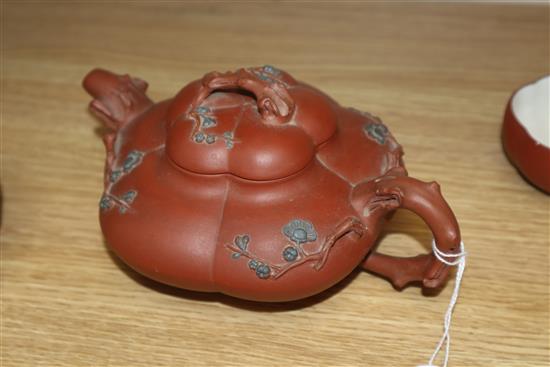 A Yixing pottery teapot and three cups